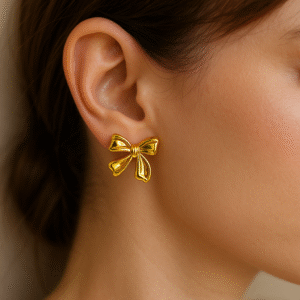Statement bow earrings in glossy gold finish