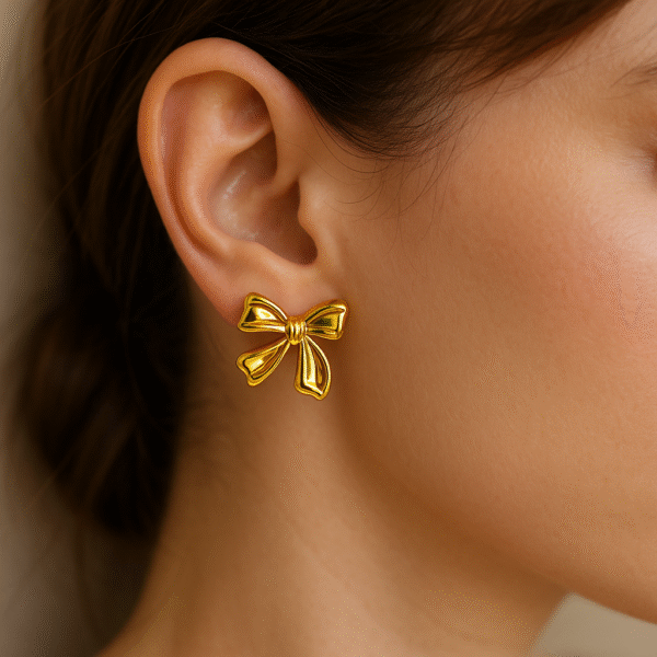 Statement bow earrings in glossy gold finish